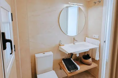 a bathroom with a sink and a mirror at Apartamento prémium con 5 Piscinas Barbacoa Tenis Frontenis in Mareny Blau
