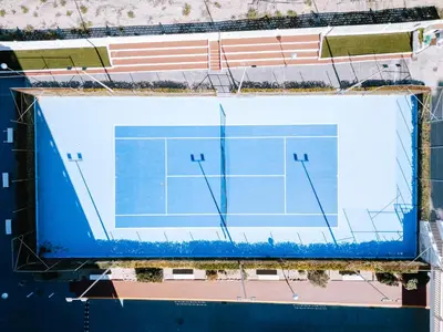 an overhead view of a tennis court at Apartamento prémium con 5 Piscinas Barbacoa Tenis Frontenis in Mareny Blau