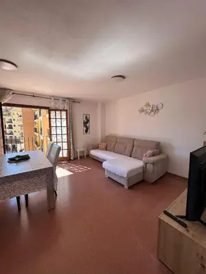 a living room with a couch and a table at Port Saplaya 1 Valencia in Port Saplaya