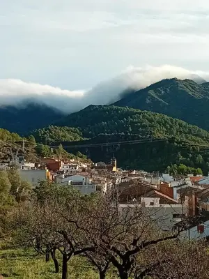 a small town in front of a mountain at La Viajera Espadan in Algimia de Almonacid
