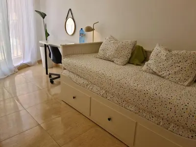 a bed in a room with a desk and a bed sidx sidx sidx at La Viajera Espadan in Algimia de Almonacid