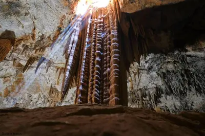 a cave with rusty pipes on the side of it at La Viajera Espadan in Algimia de Almonacid