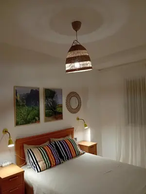 a bedroom with a bed and a pendant light at La Viajera Espadan in Algimia de Almonacid