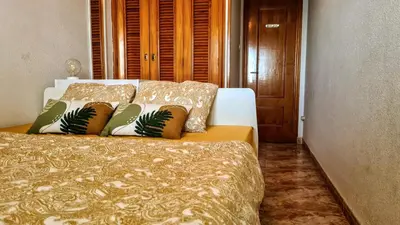 a bed with pillows on it in a bedroom at Apartmán pri mori in El Brosquil