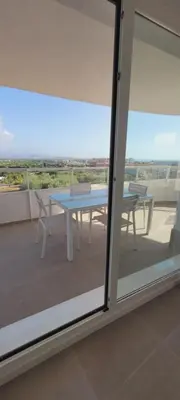 a table and chairs on a balcony with a view at Apartamento con vistas en Gran Canet in Canet de Berenguer