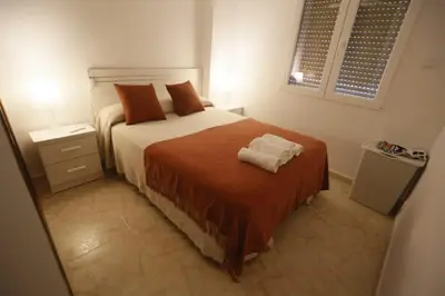 a bedroom with a bed with two towels on it at LA CULLERINA playa San Antonio con Internet Alta Velocidad Aire Acondicionado in Cullera
