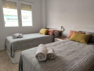 a bedroom with two beds with towels on them at LA CULLERINA playa San Antonio con Internet Alta Velocidad Aire Acondicionado in Cullera