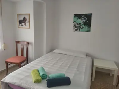 a bedroom with a bed with two pillows on it at Nice Spacious Flat in the Center in Valencia