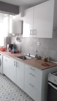 a kitchen with white cabinets and a sink at Nice Spacious Flat in the Center in Valencia