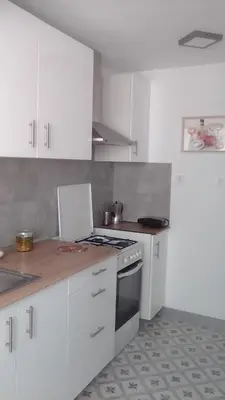 a kitchen with white cabinets and a stove top oven at Nice Spacious Flat in the Center in Valencia