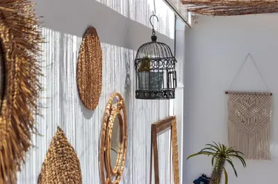 a room with a mirror and a bird cage on the wall at Precioso ático en Valencia. in Valencia