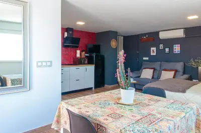 a room with a table with a bed and a couch at Precioso ático en Valencia. in Valencia