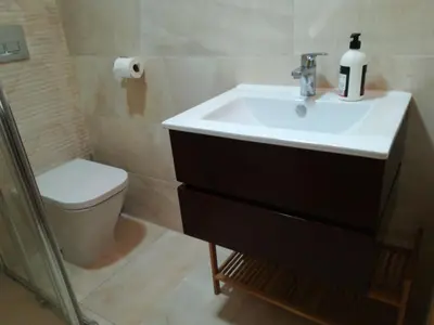 a bathroom with a sink and a toilet at Mi playa in Puerto de Sagunto