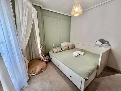 a childs bedroom with a bed with a curtain at Valencia Beach Home 23 in Valencia