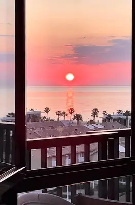 a view of a sunset from a balcony at Valencia Beach Home 23 in Valencia