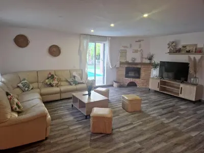a living room with a couch and a tv at Villas de descanso in Vilamarxant