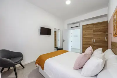 a living room with a couch and a table at AmazINN Places Valencia Cabanyal in Valencia