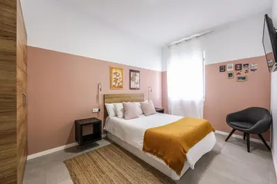 a kitchen and dining room with a table and chairs at AmazINN Places Valencia Cabanyal in Valencia