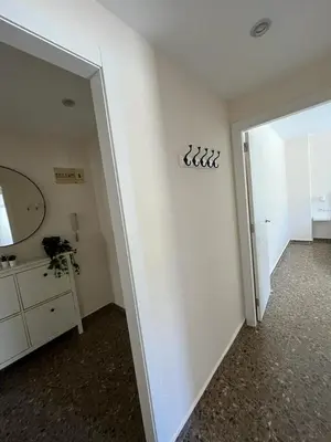 a room with a mirror and a white wall at Apartamento familiar en Cullera - Playa el Racó in Cullera