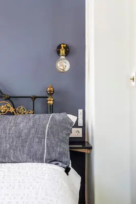a bedroom with a bed with a blue wall at Casa Rosario Cabanyal flat near the beach, high end in Valencia