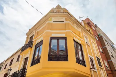 a yellow building with windows on top of it at Casa Rosario Cabanyal flat near the beach, high end in Valencia