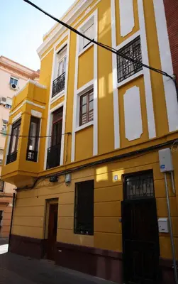 a yellow and white building on a street at Casa Rosario Cabanyal flat near the beach, high end in Valencia