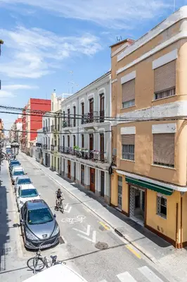 a city street with cars parked on the street at Casa Rosario Cabanyal flat near the beach, high end in Valencia