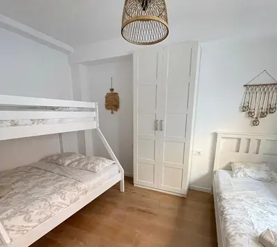 a bedroom with two bunk beds and a chandelier at UIM Mediterraneo PB Virgen del Carmen Wifi in Puerto de Sagunto