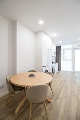 a dining room with a wooden table and chairs at Cid 90 Flat by Concept in Valencia
