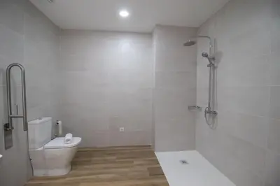 a white bathroom with a toilet and a shower at Cid 90 Flat by Concept in Valencia