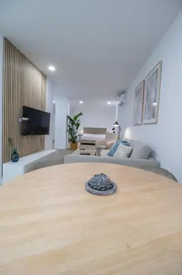 a large wooden table in a living room with a couch at Cid 90 Flat by Concept in Valencia