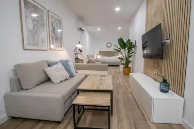 a living room with a couch and a table at Cid Flats by Concept in Valencia