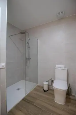 a bathroom with a toilet and a glass shower at Cid Flats by Concept in Valencia
