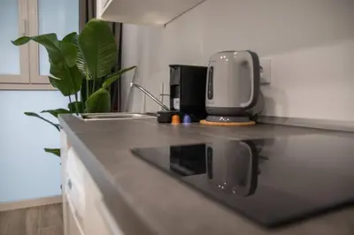 a kitchen counter with a coffee maker on top of it at Cid Flats by Concept in Valencia