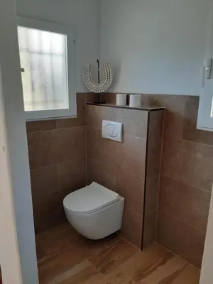 a bathroom with a toilet and a window at Casa Vitalis in Vilamarxant