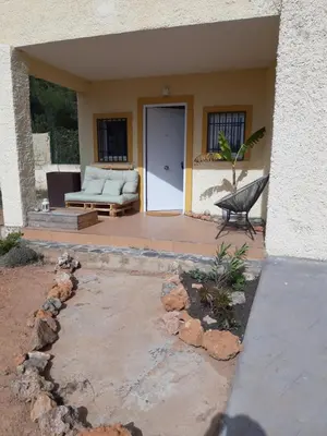 a porch of a house with a bench and a door at Casa Vitalis in Vilamarxant