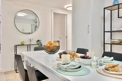 a white dining room with a table with food on it at SPACIOUS, SUNNY FLAT BY CITY OF ARTS & SCIENCES in Valencia