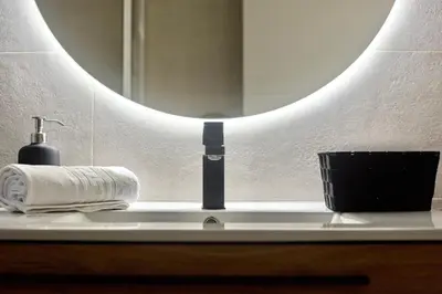 a bathroom counter with a mirror and a towel at SPACIOUS, SUNNY FLAT BY CITY OF ARTS & SCIENCES in Valencia