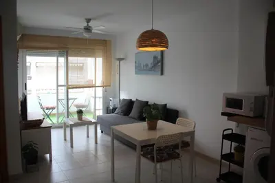 a living room with a couch and a table at TBC The Beach Corner in Canet de Berenguer