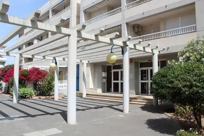 a large white building with white columns and lights at TBC The Beach Corner in Canet de Berenguer