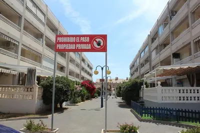 a red street sign in front of a building at TBC The Beach Corner in Canet de Berenguer