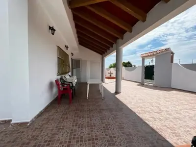 a large patio with white walls and a wooden ceiling at Casa Con Piscina Privada Marenyet in Cullera