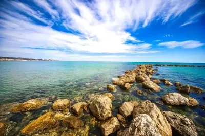a large group of rocks in the water at Casa Con Piscina Privada Marenyet in Cullera