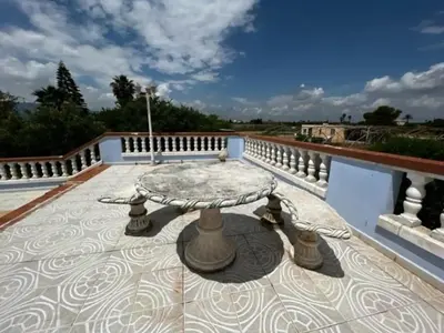 a patio with a table on a balcony at Casa Con Piscina Privada Marenyet in Cullera