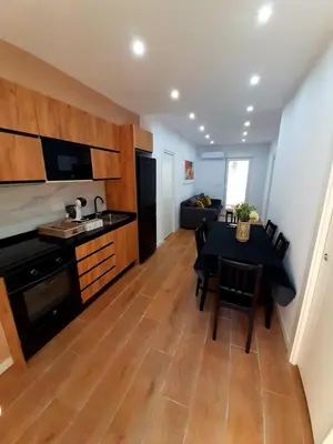 a kitchen and living room with a table and a dining room at UIM Mediterraneo CASA Virgen de los Dolores Wifi in Puerto de Sagunto