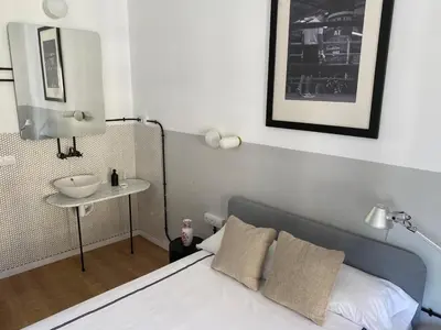a white sink sitting on a counter in a bathroom at BUBUFLATS Ayuntamiento in Valencia