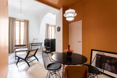 a living room with a tv and a couch and a table at BUBUFLATS Ayuntamiento in Valencia