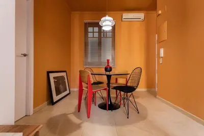 a table on a balcony with two glasses on it at BUBUFLATS Ayuntamiento in Valencia