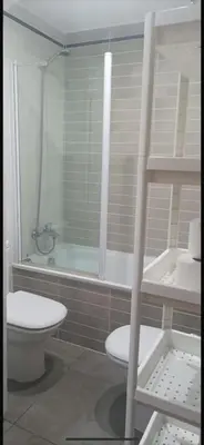 a bathroom with a toilet and a bath tub at PLAYA ALMENARA ATICO DUPLEX VISTAS AL MAR Y MONTAÑA WIFI,PISCINA a in Almenara