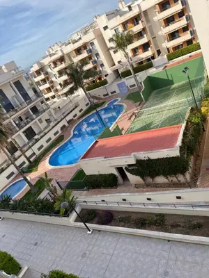 an overhead view of a resort with two swimming pools at PLAYA ALMENARA ATICO DUPLEX VISTAS AL MAR Y MONTAÑA WIFI,PISCINA a in Almenara